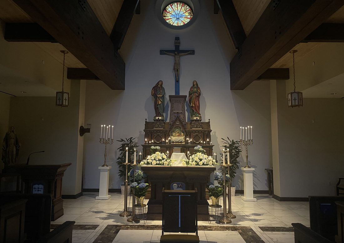 Chapel altar with a crucifix, candles and flowers