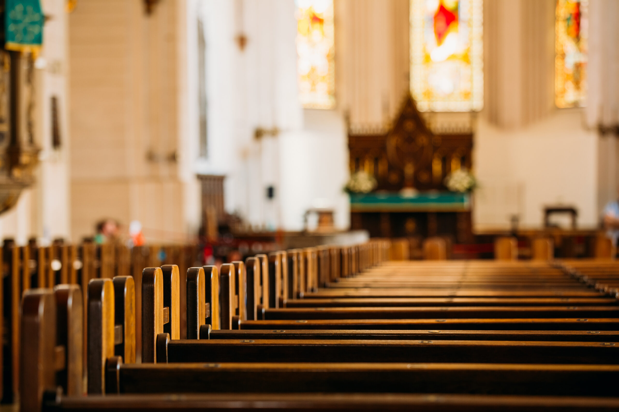 Church interior with wooden pews leading to the altar