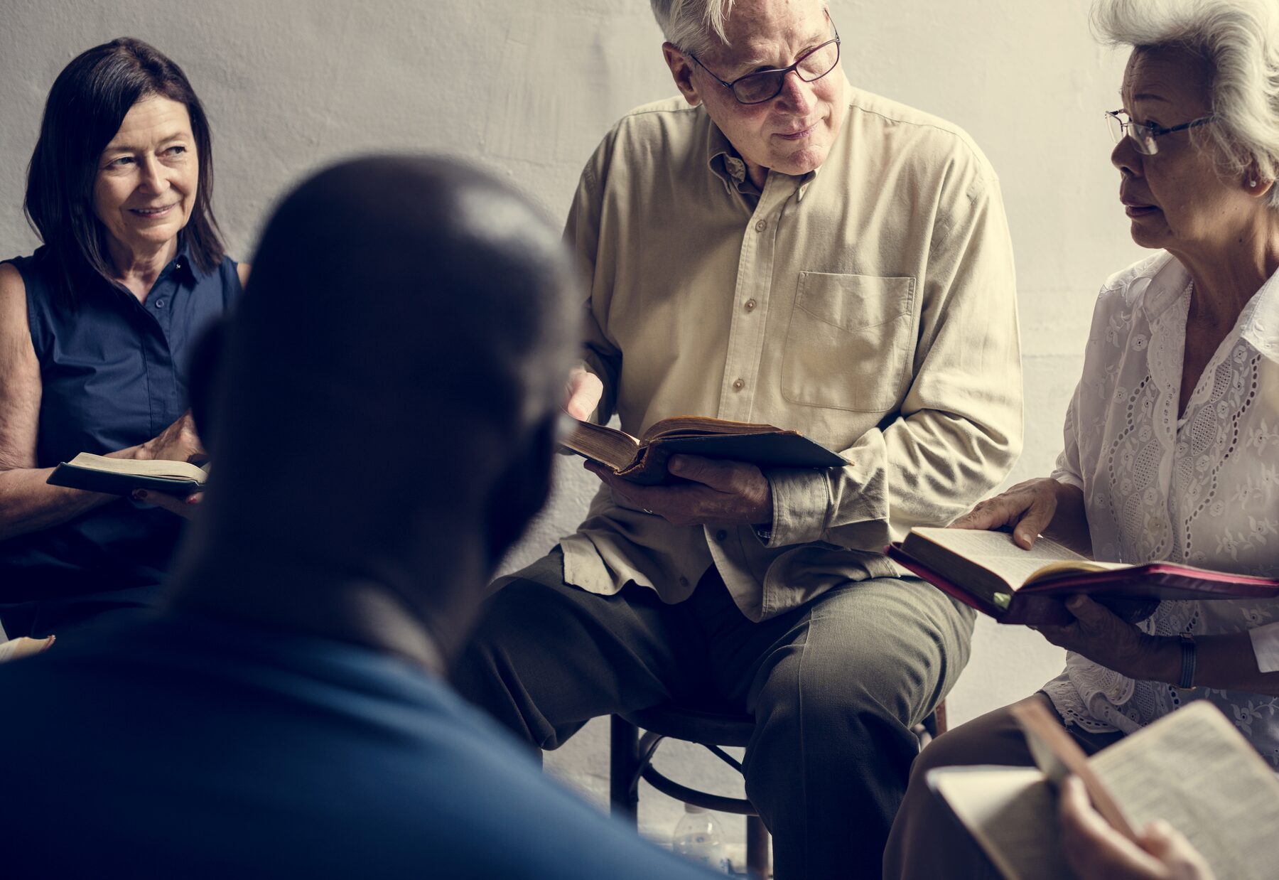 Adults reading Bibles together in a small group