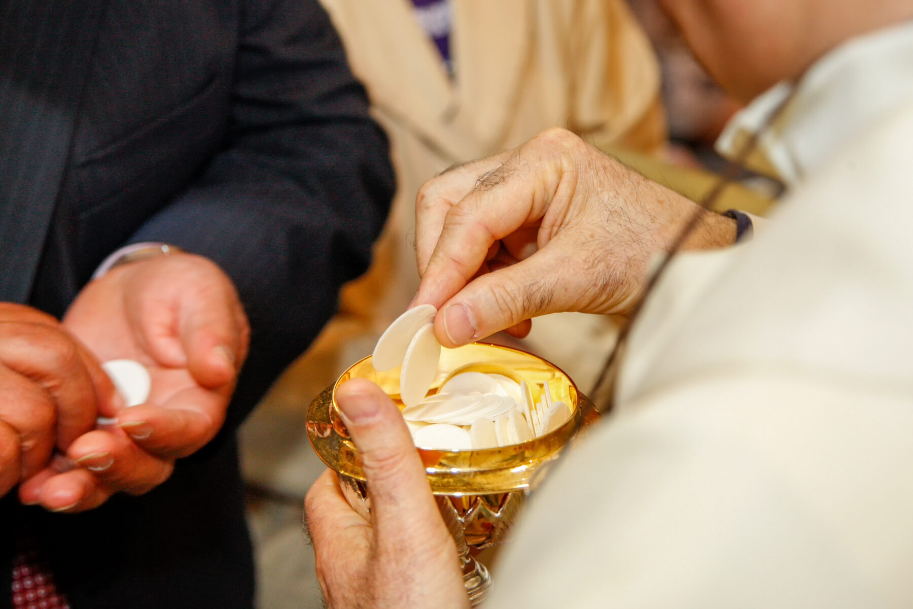 A priest distributing Holy Communion